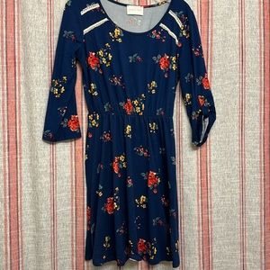 Navy blue dress with flowers. Lace design on shoulder. Mid sleeve. Size medium